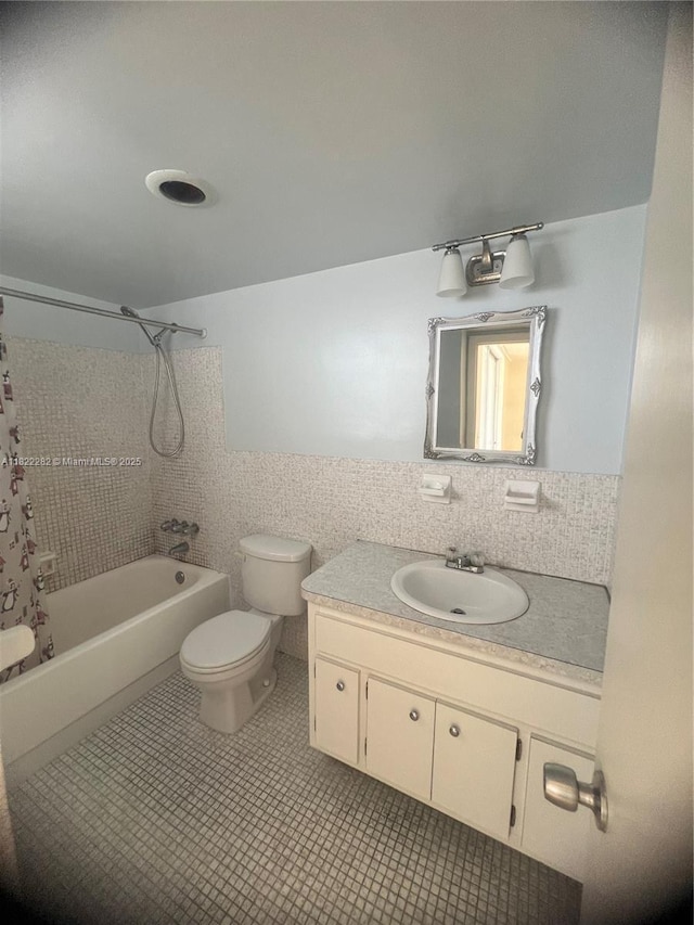 1475 NE 125th Ter Unit 511B, North Miami, FL 33161 - bathroom featuring vanity, shower / bathtub combination with curtain, tile walls, and tile patterned flooring