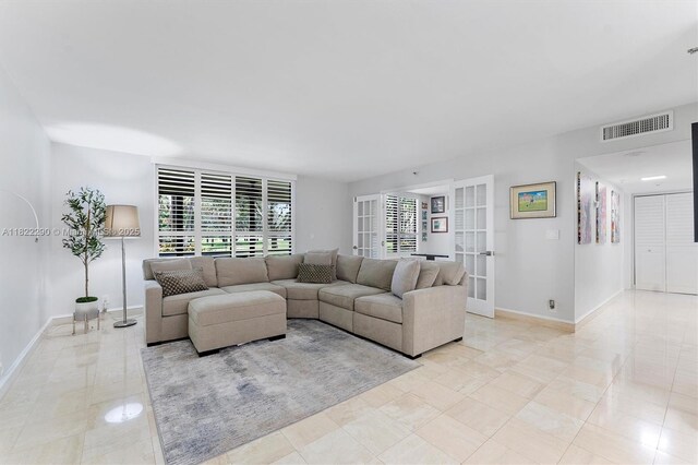 7225 Promenade Dr Unit 102, Boca Raton, FL 33433 - living room with healthy amount of natural light and french doors