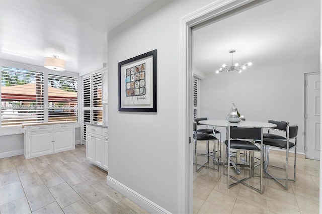 7225 Promenade Dr Unit 102, Boca Raton, FL 33433 - dining room with a chandelier and baseboards