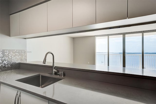 1200 Brickell Bay Dr Unit 2501, Miami, FL 33131 - kitchen featuring white cabinets, backsplash, and modern cabinets