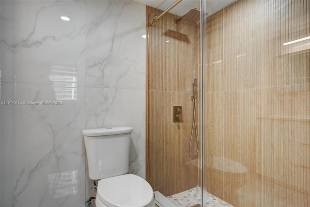 1200 Brickell Bay Dr Unit 2501, Miami, FL 33131 - bathroom featuring a marble finish shower and tile walls