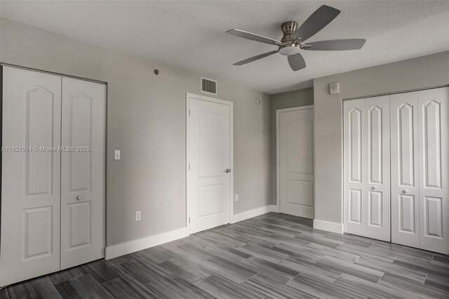 1200 Brickell Bay Dr Unit 2501, Miami, FL 33131 - unfurnished bedroom with wood finished floors, a textured ceiling, a ceiling fan, and a closet