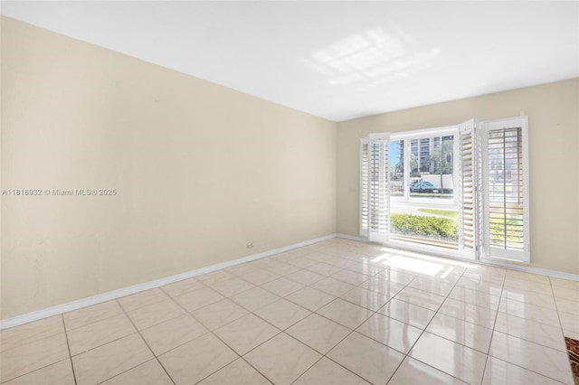 9920 Collins Ave Unit 2, Bal Harbour, FL 33154 - empty room with baseboards and light tile patterned floors