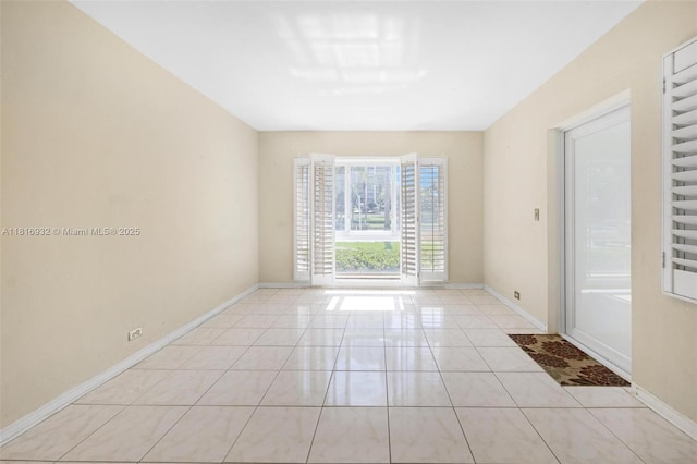 9920 Collins Ave Unit 2, Bal Harbour, FL 33154 - spare room featuring baseboards and light tile patterned floors