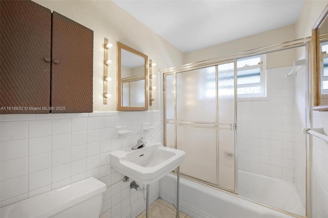 9920 Collins Ave Unit 2, Bal Harbour, FL 33154 - bathroom featuring enclosed tub / shower combo and tile walls