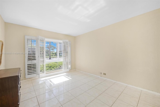9920 Collins Ave Unit 2, Bal Harbour, FL 33154 - empty room with light tile patterned flooring and baseboards