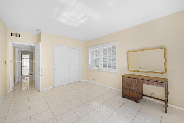 9920 Collins Ave Unit 2, Bal Harbour, FL 33154 - unfurnished bedroom with multiple windows, a closet, and light tile patterned flooring