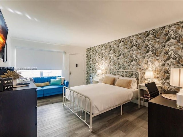 4015 Indian Creek Dr Unit 204, Miami Beach, FL 33140 - bedroom featuring wallpapered walls and wood finished floors