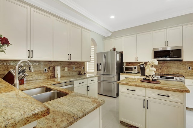 8902 NW 178th Ln, Hialeah, FL 33018 - kitchen featuring appliances with stainless steel finishes, arched walkways, light stone countertops, backsplash, and ornamental molding