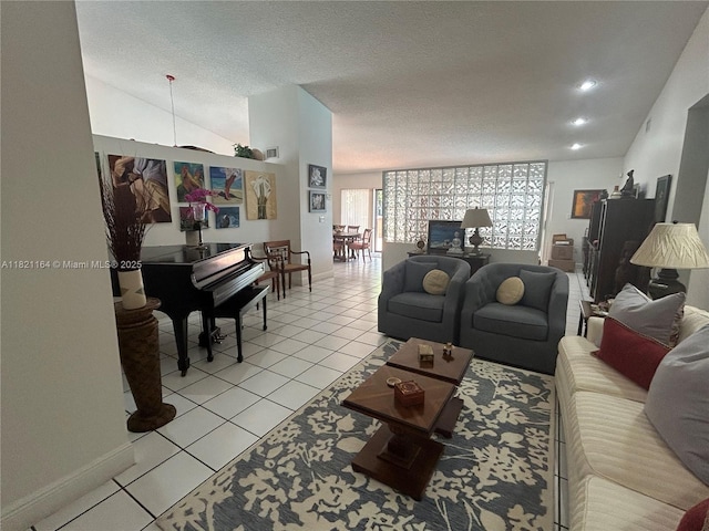 13205 SW 119th St, Miami, FL 33186 - living room with light tile patterned floors, a textured ceiling, and vaulted ceiling