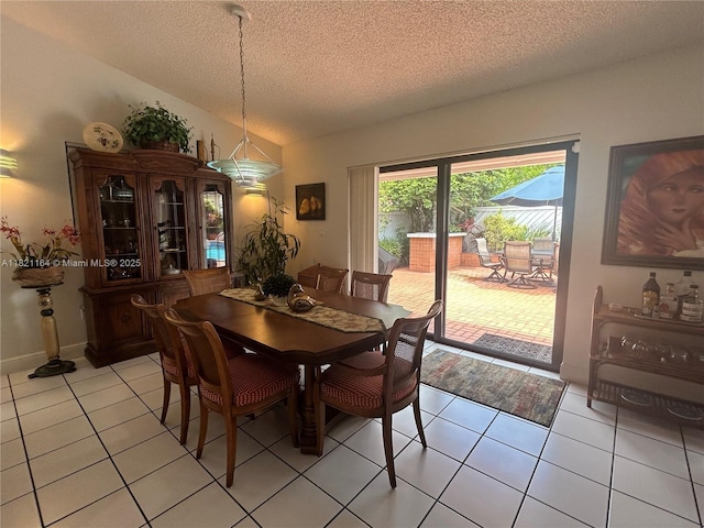 13205 SW 119th St, Miami, FL 33186 - dining area featuring a textured ceiling, light tile patterned flooring, and lofted ceiling