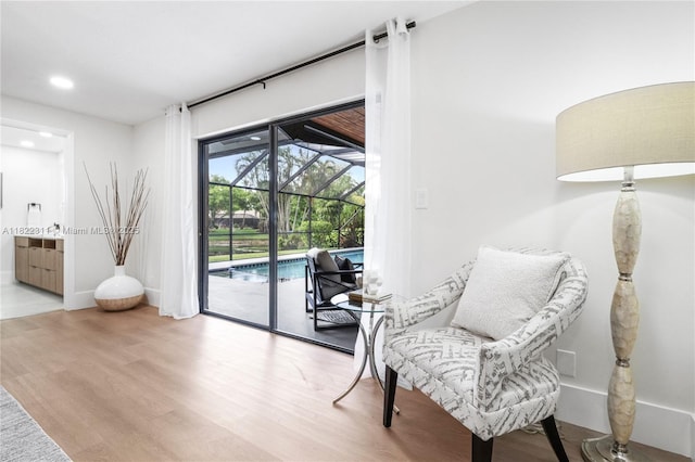 2019 NW 108th Ln, Coral Springs, FL 33071 - living area with a sunroom, wood finished floors, and recessed lighting