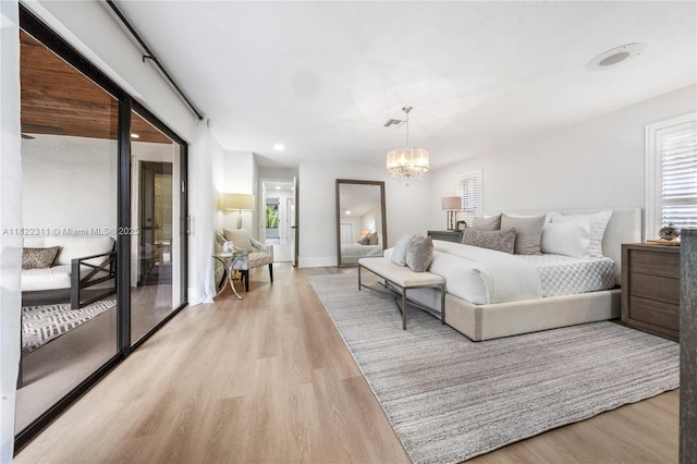 2019 NW 108th Ln, Coral Springs, FL 33071 - bedroom featuring light wood finished floors, multiple windows, a chandelier, and recessed lighting
