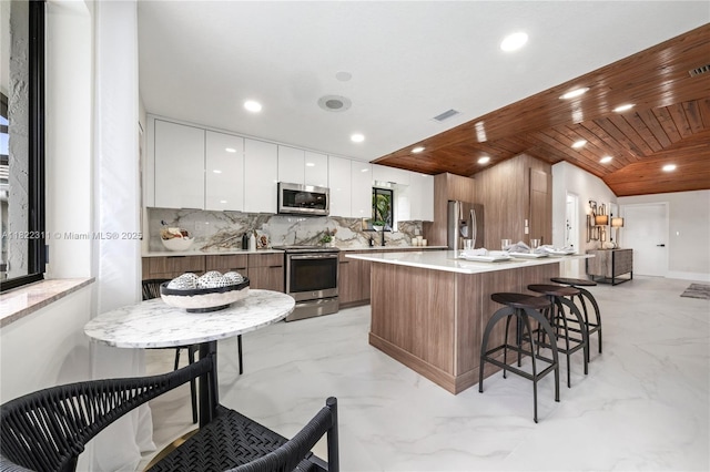 2019 NW 108th Ln, Coral Springs, FL 33071 - kitchen featuring appliances with stainless steel finishes, modern cabinets, light marble finish flooring, wood ceiling, and recessed lighting