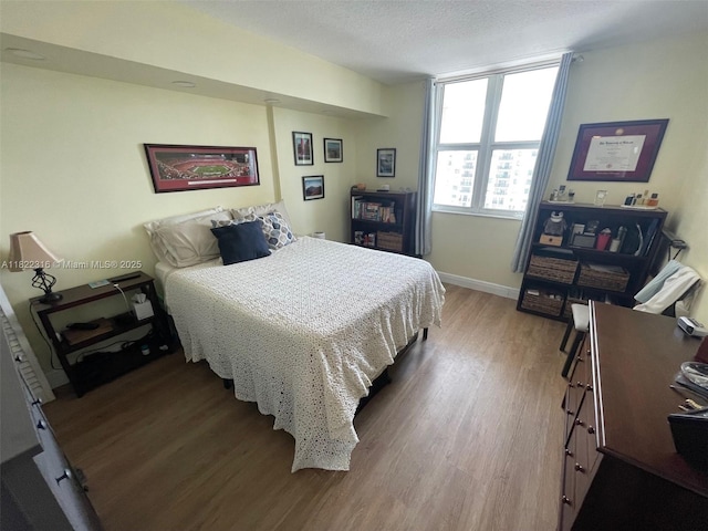 117 NW 42nd Ave Unit 1506, Miami, FL 33126 - bedroom featuring wood finished floors and a textured ceiling