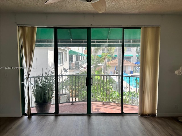 12666 NW 14th Pl Unit 12666, Sunrise, FL 33323 - entryway with wood finished floors, plenty of natural light, a textured ceiling, and a ceiling fan