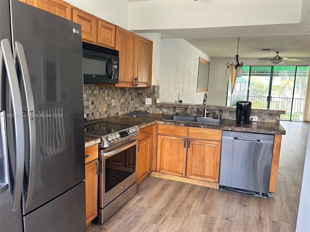 12666 NW 14th Pl Unit 12666, Sunrise, FL 33323 - kitchen with stainless steel appliances, a peninsula, ceiling fan, brown cabinets, and backsplash