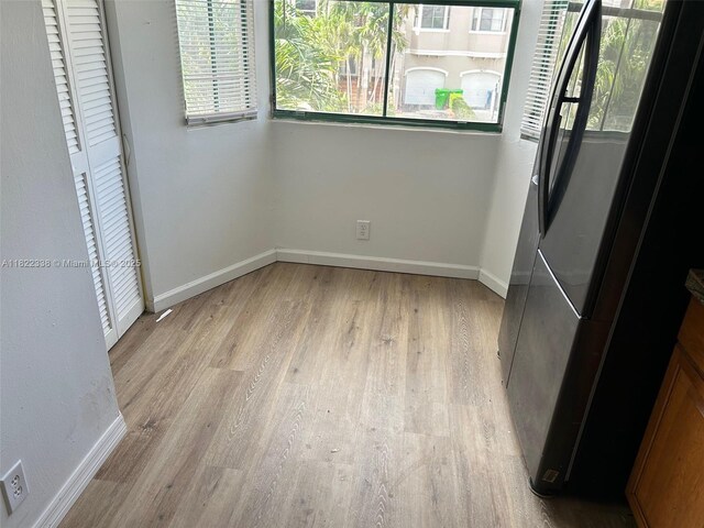 12666 NW 14th Pl Unit 12666, Sunrise, FL 33323 - unfurnished bedroom with freestanding refrigerator and light wood finished floors