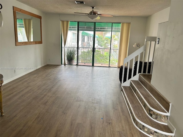 12666 NW 14th Pl Unit 12666, Sunrise, FL 33323 - unfurnished living room featuring plenty of natural light, ceiling fan, wood finished floors, a textured ceiling, and stairway