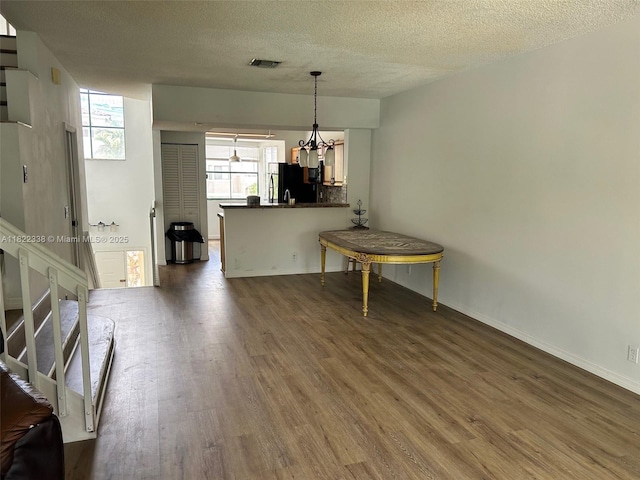12666 NW 14th Pl Unit 12666, Sunrise, FL 33323 - living area featuring wood finished floors, a textured ceiling, a chandelier, and stairway