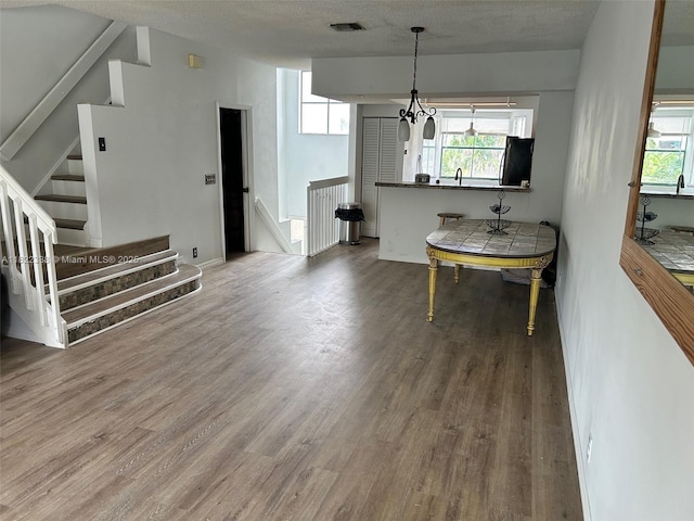 12666 NW 14th Pl Unit 12666, Sunrise, FL 33323 - living area featuring wood finished floors, plenty of natural light, stairway, and a textured ceiling
