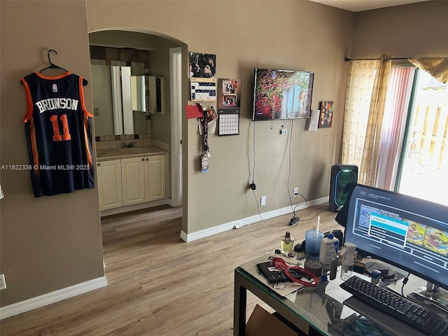 12666 NW 14th Pl Unit 12666, Sunrise, FL 33323 - home office featuring arched walkways and light wood-style floors