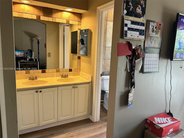 12666 NW 14th Pl Unit 12666, Sunrise, FL 33323 - bathroom featuring wood finished floors and double vanity