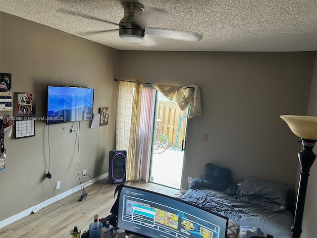 12666 NW 14th Pl Unit 12666, Sunrise, FL 33323 - bedroom featuring wood finished floors, multiple windows, a textured ceiling, and ceiling fan
