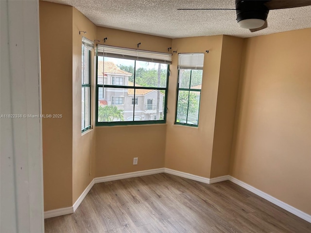 12666 NW 14th Pl Unit 12666, Sunrise, FL 33323 - empty room featuring wood finished floors, a textured ceiling, and a ceiling fan