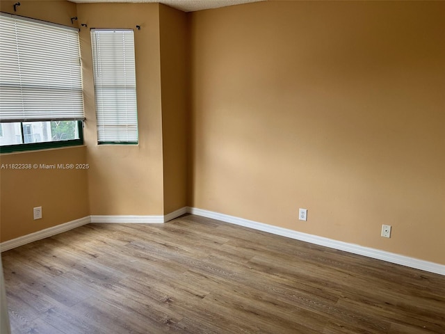 12666 NW 14th Pl Unit 12666, Sunrise, FL 33323 - unfurnished room with wood finished floors and baseboards