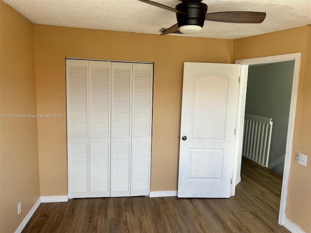 12666 NW 14th Pl Unit 12666, Sunrise, FL 33323 - unfurnished bedroom featuring dark wood-style flooring, a closet, a textured ceiling, and a ceiling fan