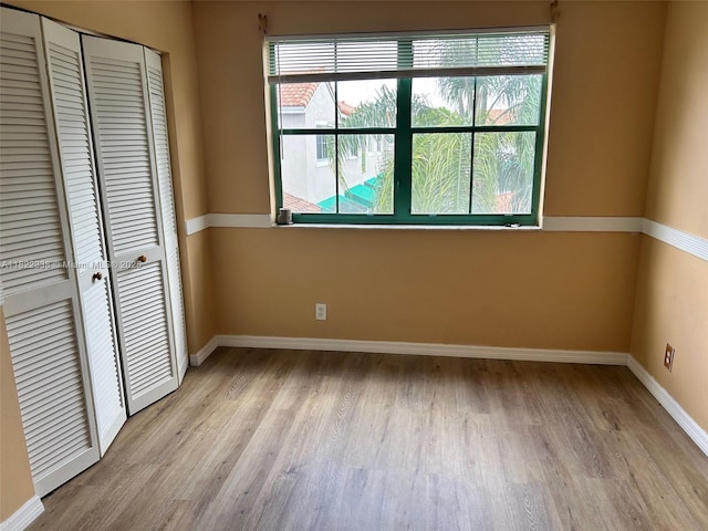 12666 NW 14th Pl Unit 12666, Sunrise, FL 33323 - unfurnished bedroom featuring light wood-style flooring and a closet