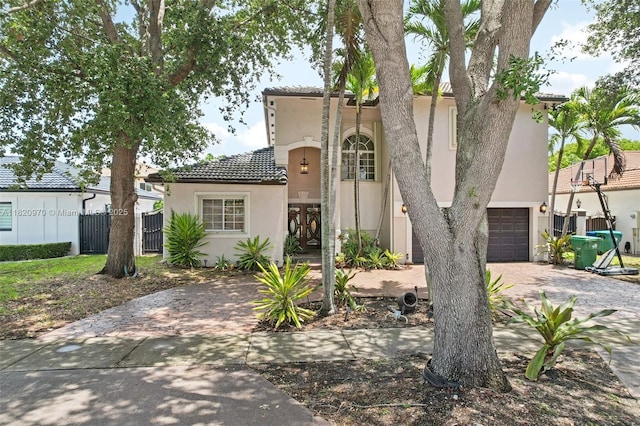 8981 NW 166th Ter, Miami Lakes, FL 33018 - mediterranean / spanish home with driveway, stucco siding, a tiled roof, and an attached garage