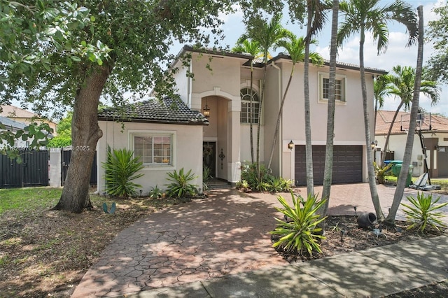 8981 NW 166th Ter, Miami Lakes, FL 33018 - mediterranean / spanish-style home with a garage, stucco siding, driveway, and a tiled roof