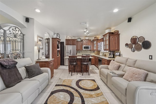 8981 NW 166th Ter, Miami Lakes, FL 33018 - living room featuring arched walkways and recessed lighting
