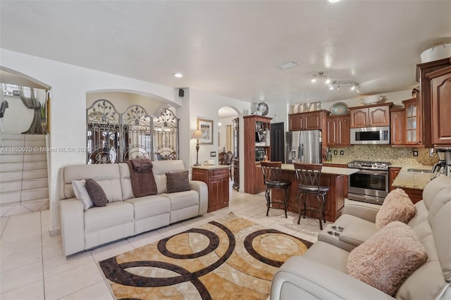 8981 NW 166th Ter, Miami Lakes, FL 33018 - living room with arched walkways, light tile patterned flooring, and recessed lighting