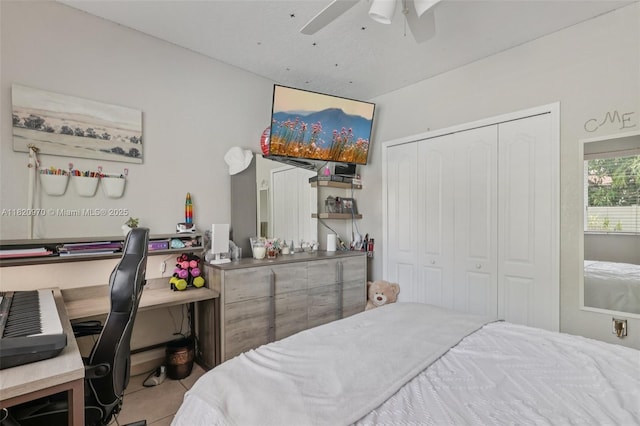 8981 NW 166th Ter, Miami Lakes, FL 33018 - bedroom with a desk, a closet, a ceiling fan, and tile patterned floors