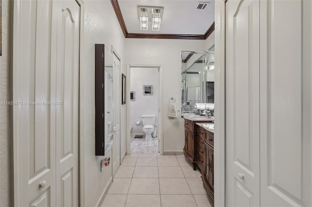 8981 NW 166th Ter, Miami Lakes, FL 33018 - bathroom featuring vanity, ornamental molding, tile patterned flooring, and a closet