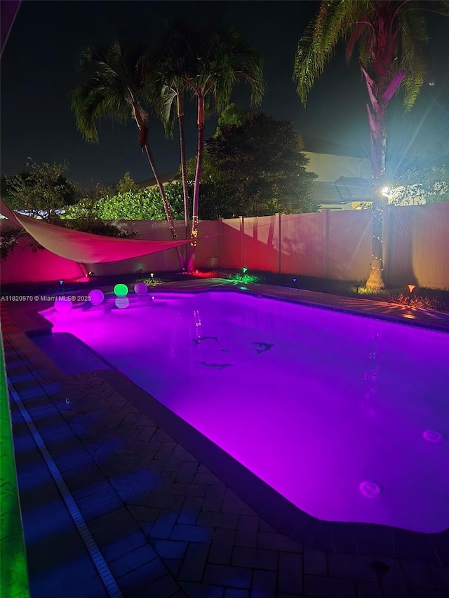 8981 NW 166th Ter, Miami Lakes, FL 33018 - pool at twilight with a fenced backyard