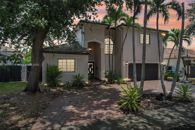 8981 NW 166th Ter, Miami Lakes, FL 33018 - mediterranean / spanish-style home with stucco siding, driveway, an attached garage, and a tiled roof