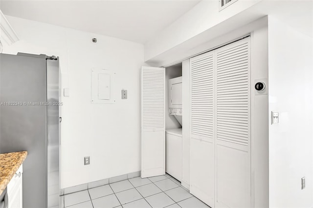 9341 Collins Ave Unit 705, Surfside, FL 33154 - interior space featuring stacked washer and clothes dryer, electric panel, and light tile patterned floors