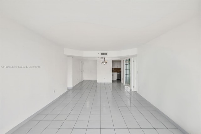 9341 Collins Ave Unit 705, Surfside, FL 33154 - spare room featuring a chandelier and light tile patterned flooring