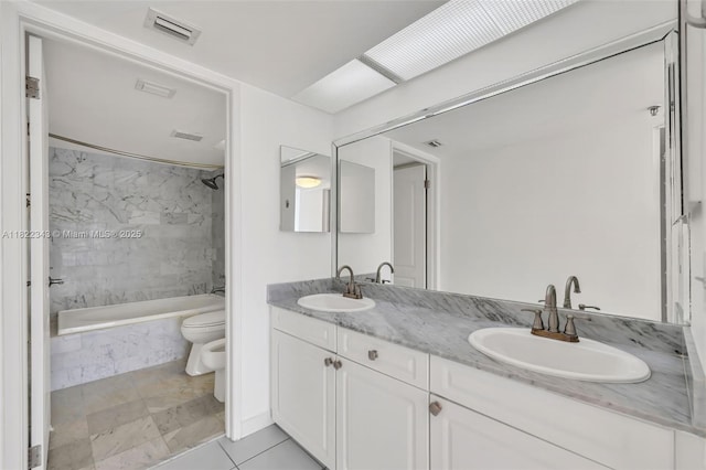 9341 Collins Ave Unit 705, Surfside, FL 33154 - bathroom with tiled shower / bath, double vanity, tile patterned flooring, and a bidet