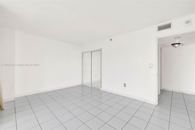 9341 Collins Ave Unit 705, Surfside, FL 33154 - spare room featuring light tile patterned floors and baseboards