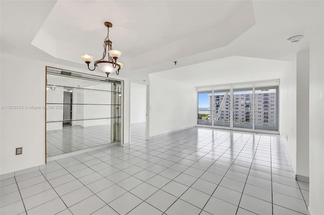 9341 Collins Ave Unit 705, Surfside, FL 33154 - empty room featuring a chandelier and light tile patterned flooring