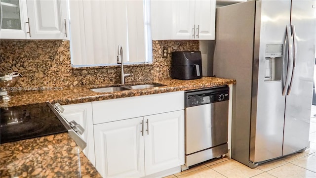 7795 Granada Blvd, Miramar, FL 33023 - kitchen featuring stainless steel appliances, white cabinetry, tasteful backsplash, and dark stone counters