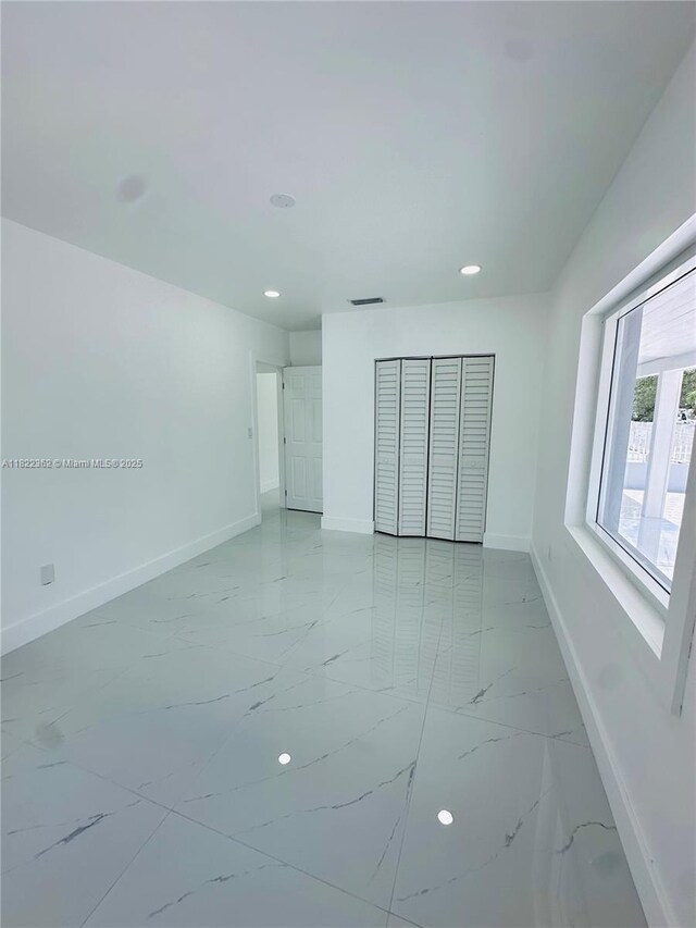 82 E 16th St, Hialeah, FL 33010 - spare room featuring recessed lighting and light marble finish floors