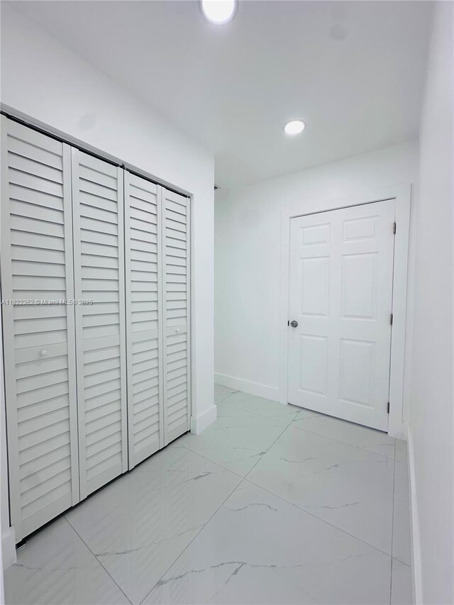 82 E 16th St, Hialeah, FL 33010 - unfurnished bedroom with recessed lighting, light marble finish flooring, and a closet