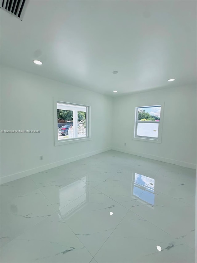 82 E 16th St, Hialeah, FL 33010 - spare room with healthy amount of natural light, light marble finish floors, and recessed lighting