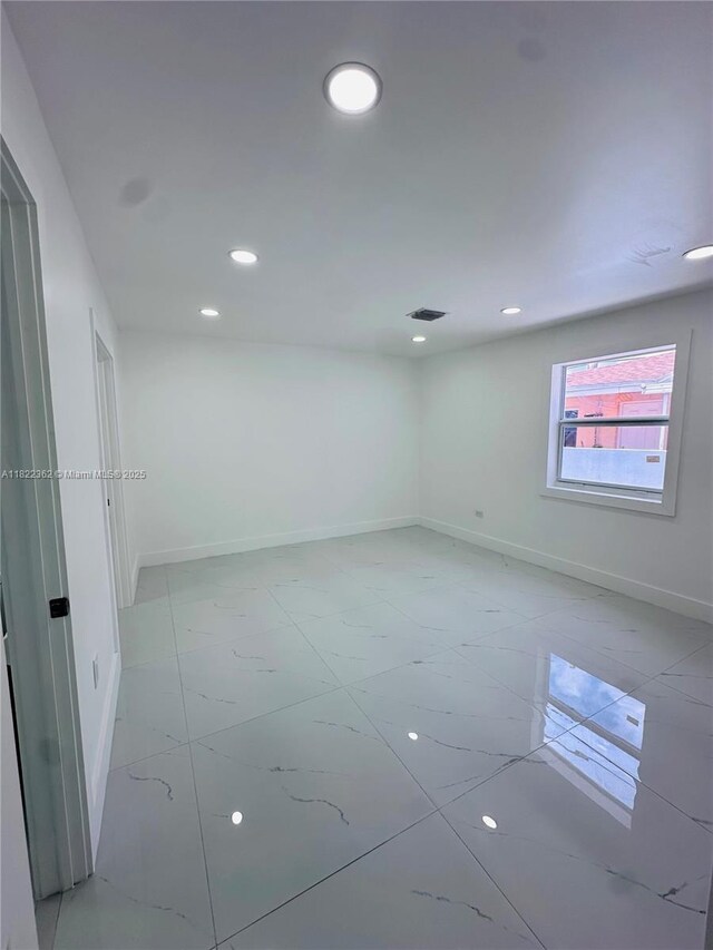82 E 16th St, Hialeah, FL 33010 - spare room with recessed lighting and light marble finish flooring